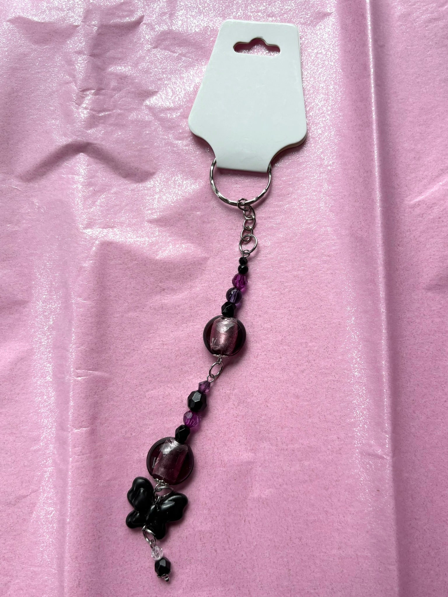 Beaded keychain on a pink fabric background