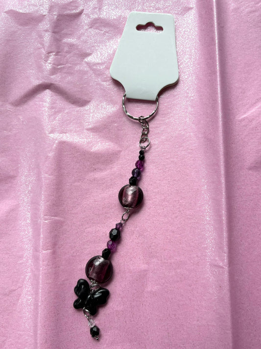 Beaded keychain on a pink fabric background