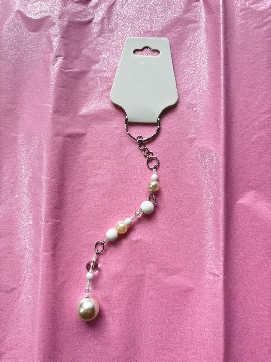 Pearl necklace on a pink background