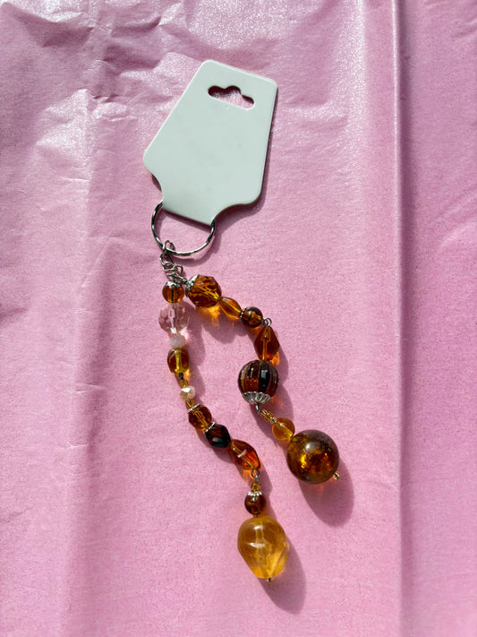 Beaded keychain on a pink fabric background