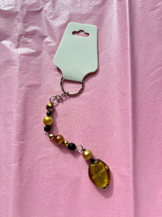 Beaded keychain with a pendant on a pink background