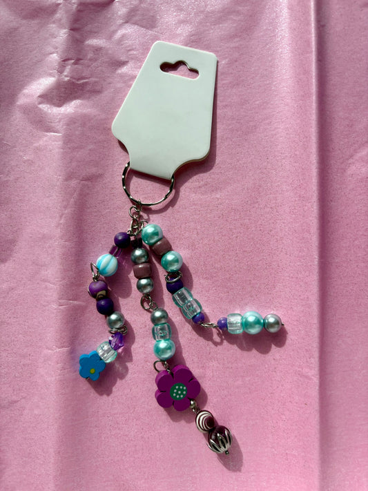 Colorful beaded keychain on a pink background